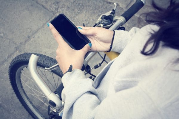 woman using smart phone on bike