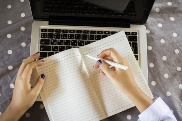 young girl writes in a diary