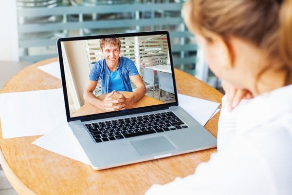 video call. woman and man talking on web camera in office
